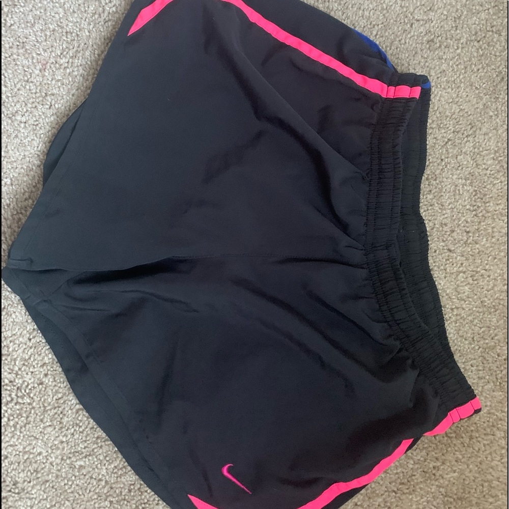 Black Nike athletic shorts with hot pink and blue details